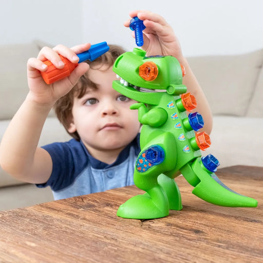 Young boy using construction tool with the T-Rex Design & Drill